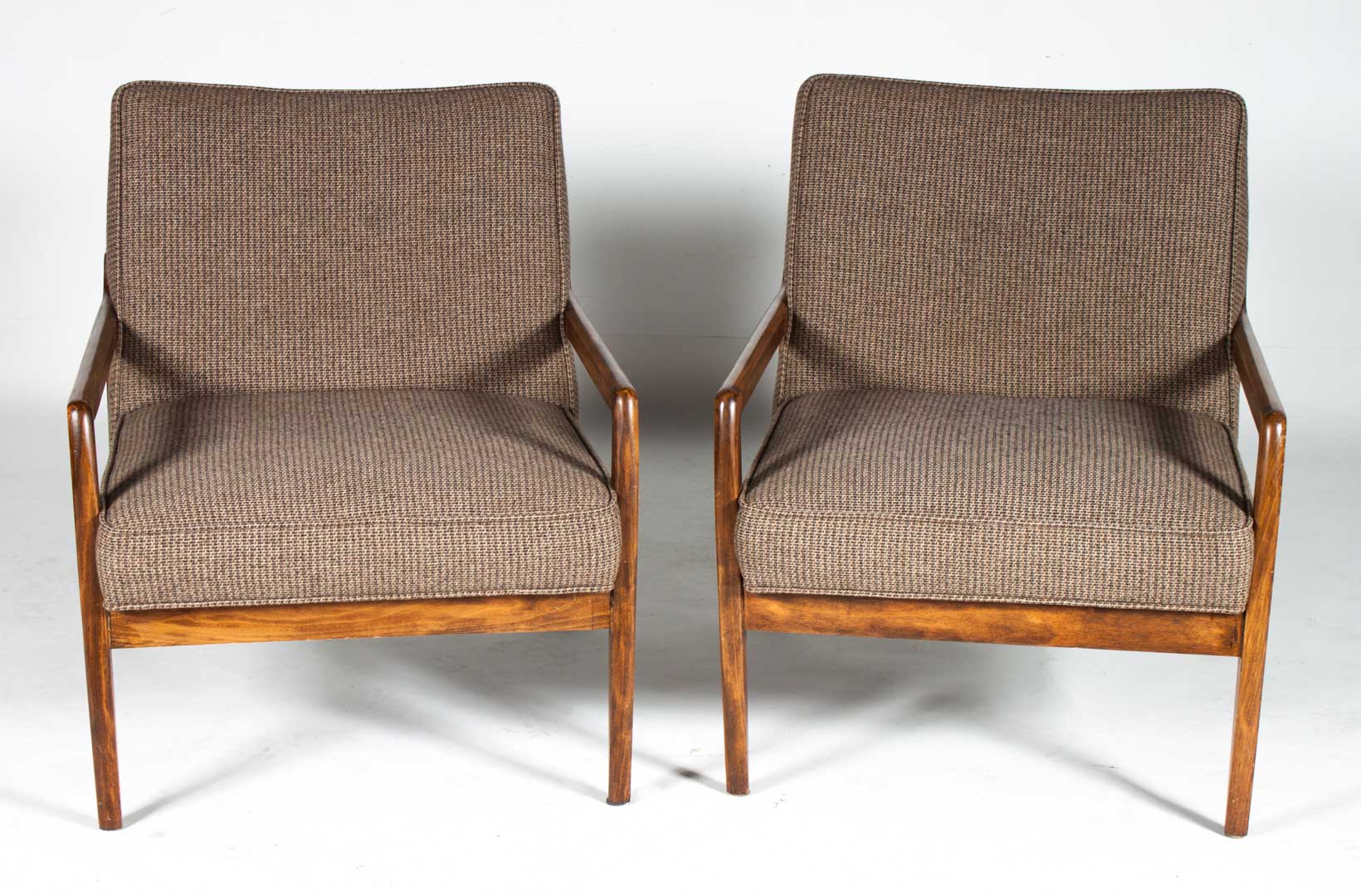 Appraisal: Pr Mid-century Modern teakwood lounge chairs circa s tweed upholstered