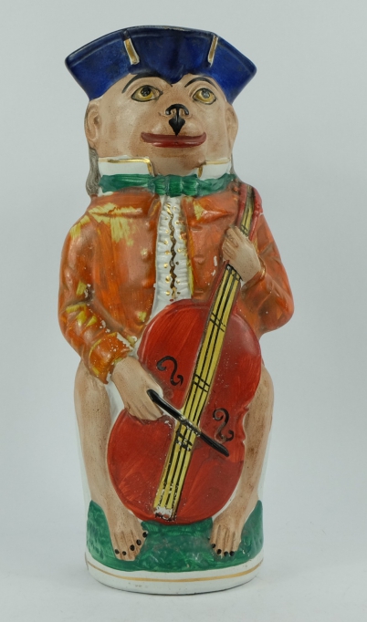 Appraisal: th century Staffordshire Toby jug as a Monkey Musician height