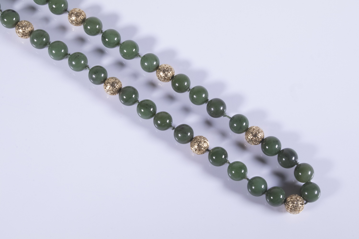 Appraisal: K GOLD AND JADE BEAD NECKLACE long strand of mm