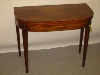 Appraisal: A GEORGE III MAHOGANY FOLDING TEA TABLE of rounded oblong