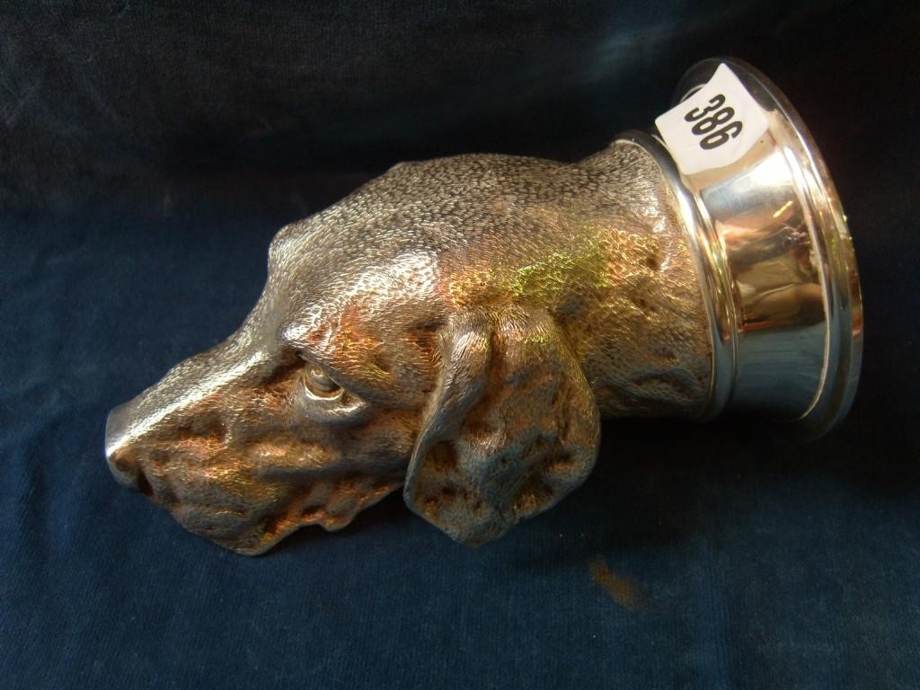 Appraisal: A silver stirrup cup in the form of a German