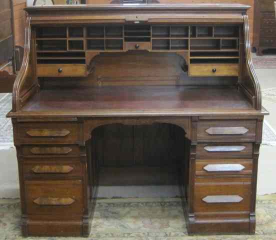 Appraisal: A VICTORIAN WALNUT ROLL-TOP DESK American c having a sliding