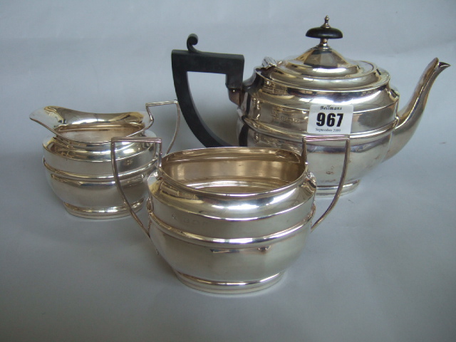 Appraisal: A silver three piece tea set of panelled oval form