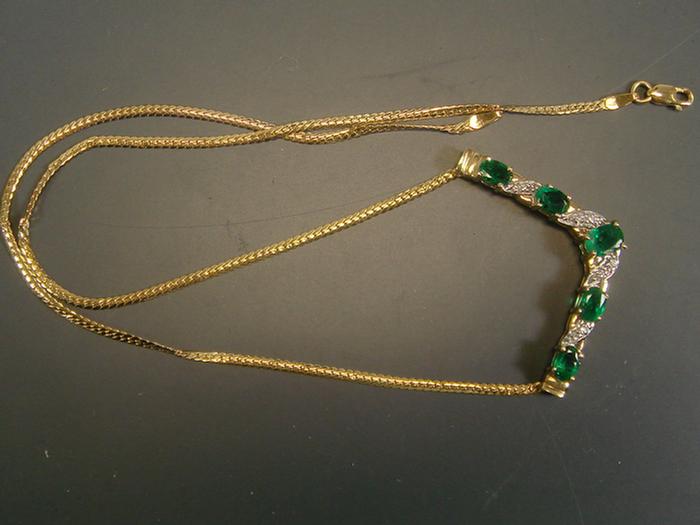 Appraisal: K YG diamond and emerald necklace set with five oval