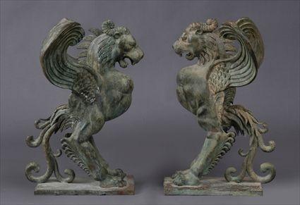 Appraisal: PAIR OF CAST METAL FIGURES OF GRIFFINS Each growling winged