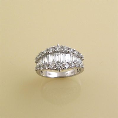 Appraisal: A diamond set half hoop ring Centred with a line