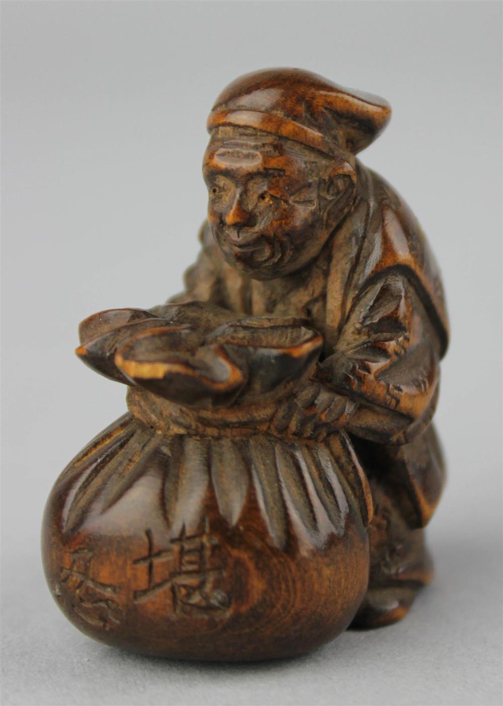 Appraisal: WOOD NETSUKE OF AN OLDER MAN POSSIBLY HOTEI WITH HIS