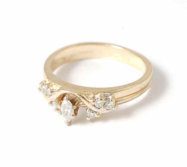 Appraisal: DIAMOND AND FOURTEEN KARAT YELLOW GOLD RING set with six