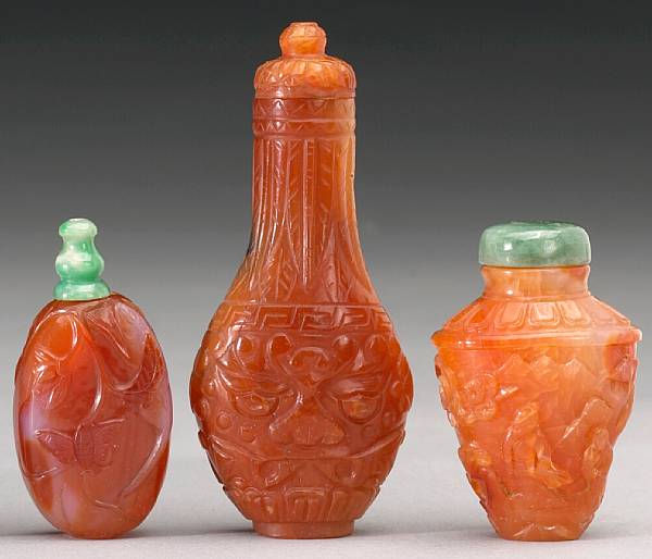 Appraisal: Three carnelian agate snuff bottles The first in the form