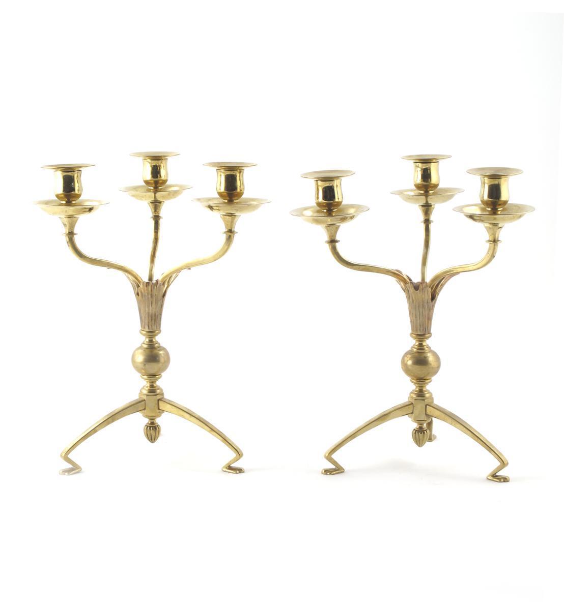 Appraisal: A pair of brass and copper three-light candlesticks