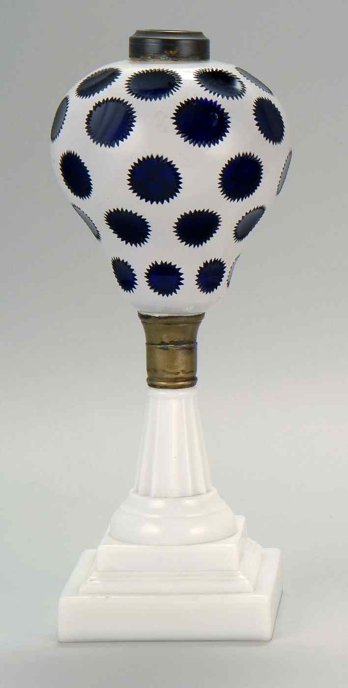 Appraisal: GLASS OIL LAMPFont with white-cut-to-cobalt blue medallions Brass mid-section and