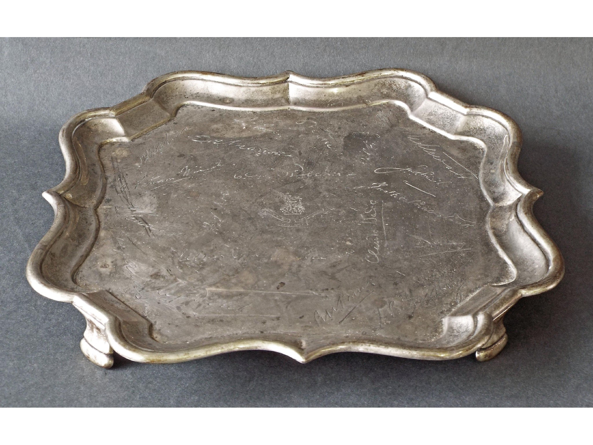 Appraisal: Edwardian silver square serpentine salver engraved with a Military crest