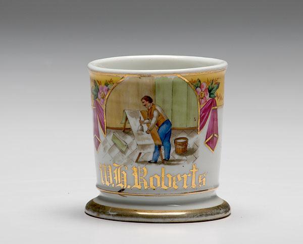 Appraisal: WALLPAPER HANGER'S OCCUPATIONAL SHAVING MUG porcelain polychrome painted scene of