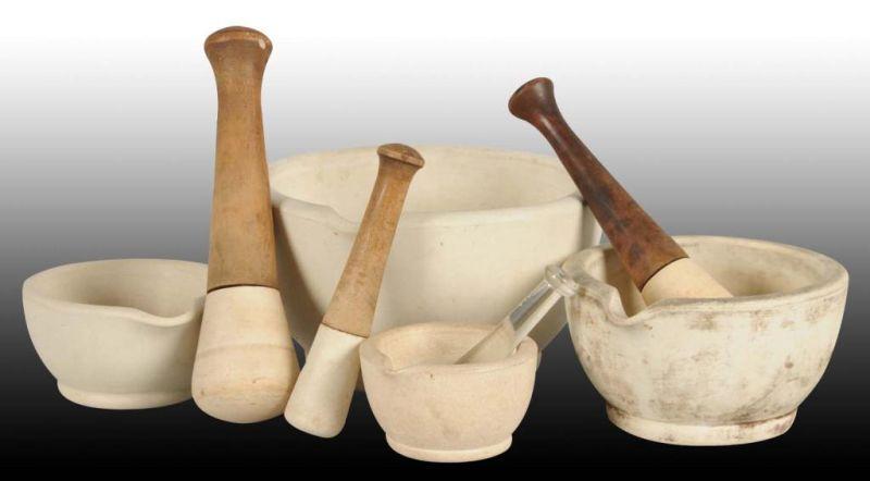 Appraisal: Lot of Graduated Mortars and Pestles Description One bowl has