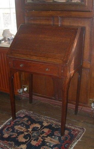 Appraisal: A George III oak bureau the hinged fall concealing nine