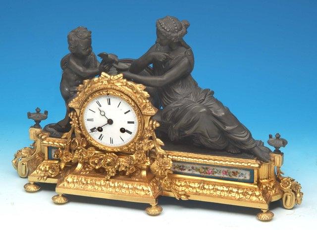 Appraisal: A Continental mantel clock the case with sculptured figures of