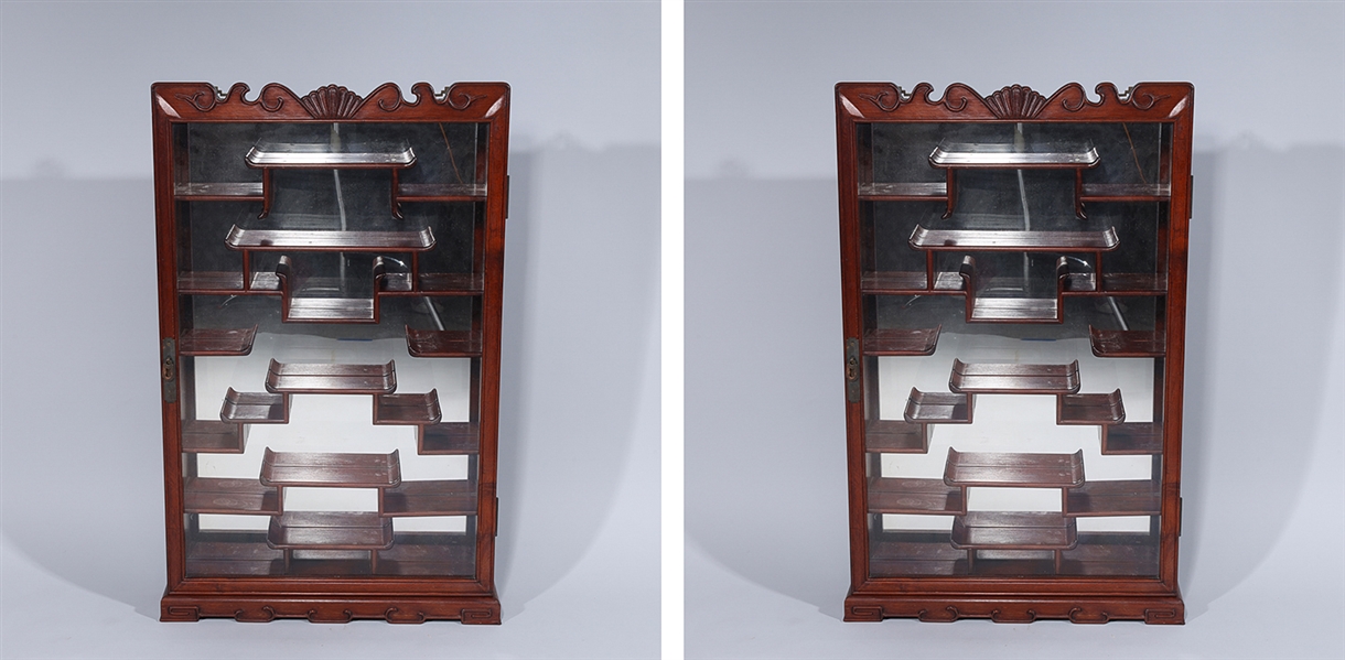 Appraisal: Pair of Chinese wood curio cabinet with glass door metal