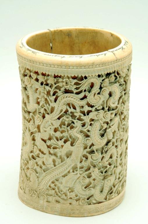 Appraisal: An ivory tusk profusely carved with dragons birds and fish