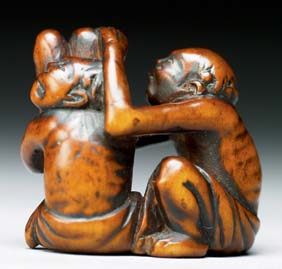 Appraisal: ANTIQUE WOOD NETSUKE Antique carved wood netsuke of two seated