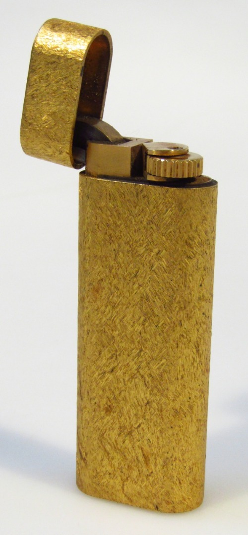 Appraisal: A Cartier gilt cigarette lighter in textured gilt case signed