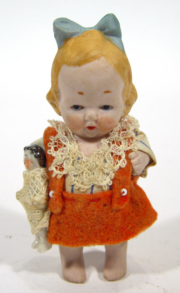 Appraisal: Hand painted bisque figure of a child clutching a doll