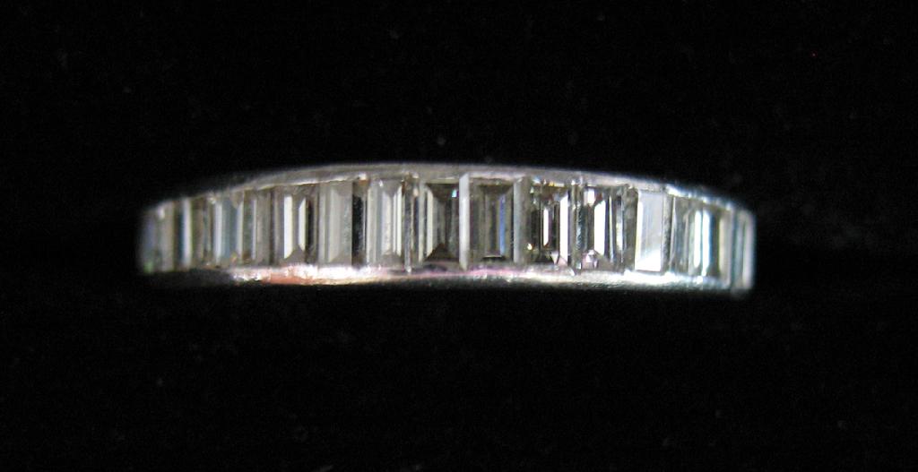 Appraisal: A HALF DIAMOND ETERNITY RING set to the top with