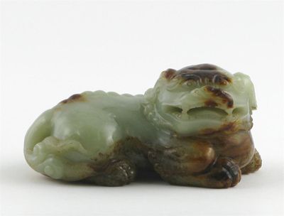 Appraisal: A Chinese jade Buddhistic lion with pronounced spines areas of