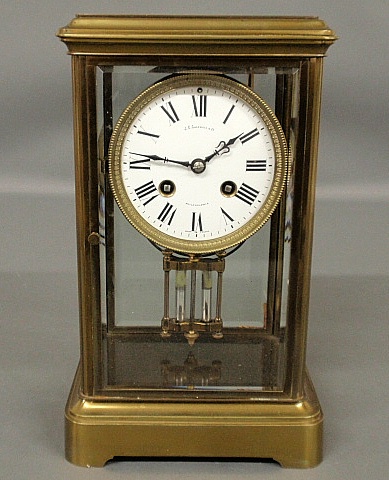 Appraisal: - French brass and beveled glass mantel clock with a