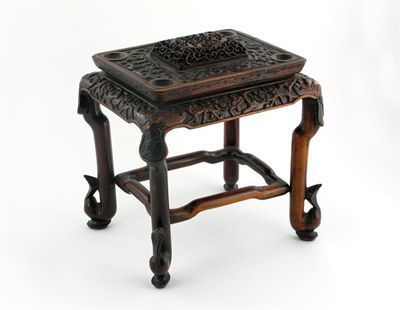 Appraisal: A Chinese hardwood rectangular stand carved with prunus scrolls and