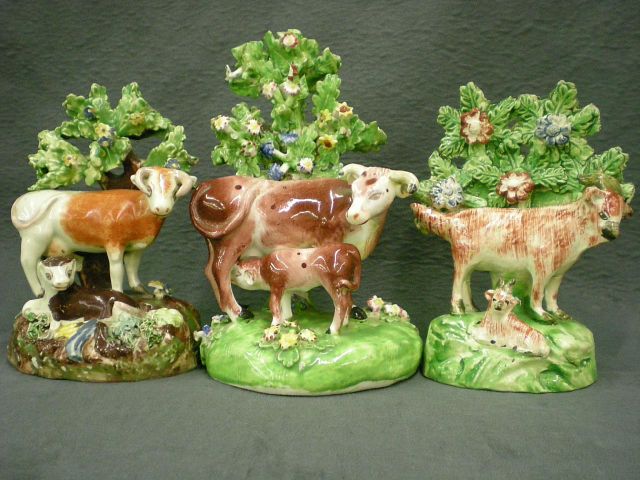 Appraisal: Three Staffordshire animal motif figurines including figure of cow with