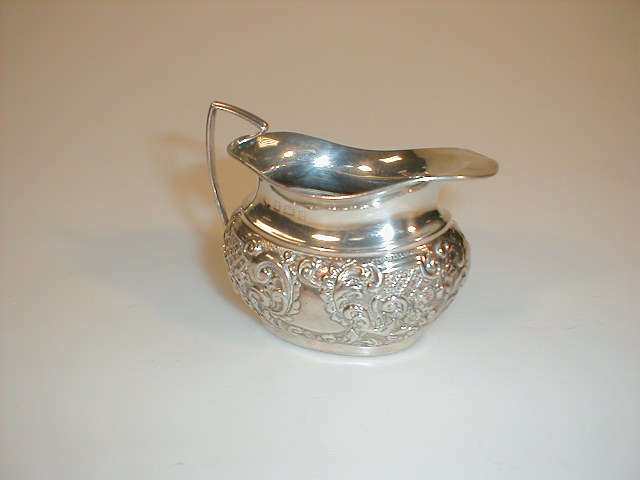 Appraisal: An Edwardian silver London shaped cream jug with repouss decoration