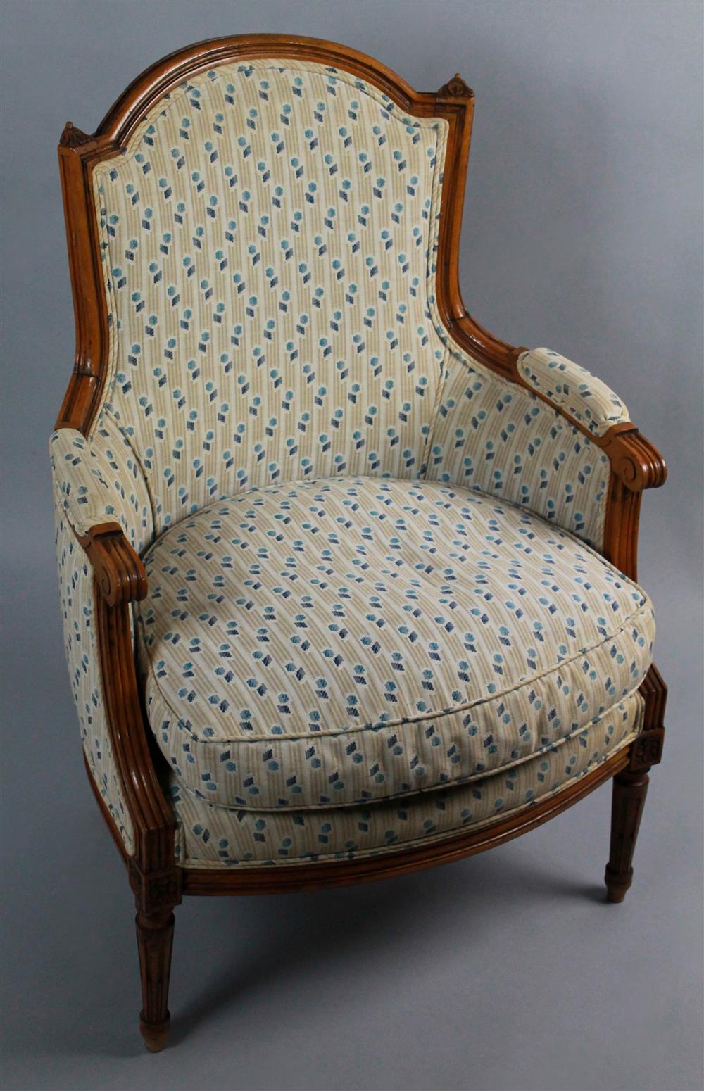 Appraisal: LOUIS XVI STYLE FRUITWOOD BERGERE WITH DOWN SEAT arched crest