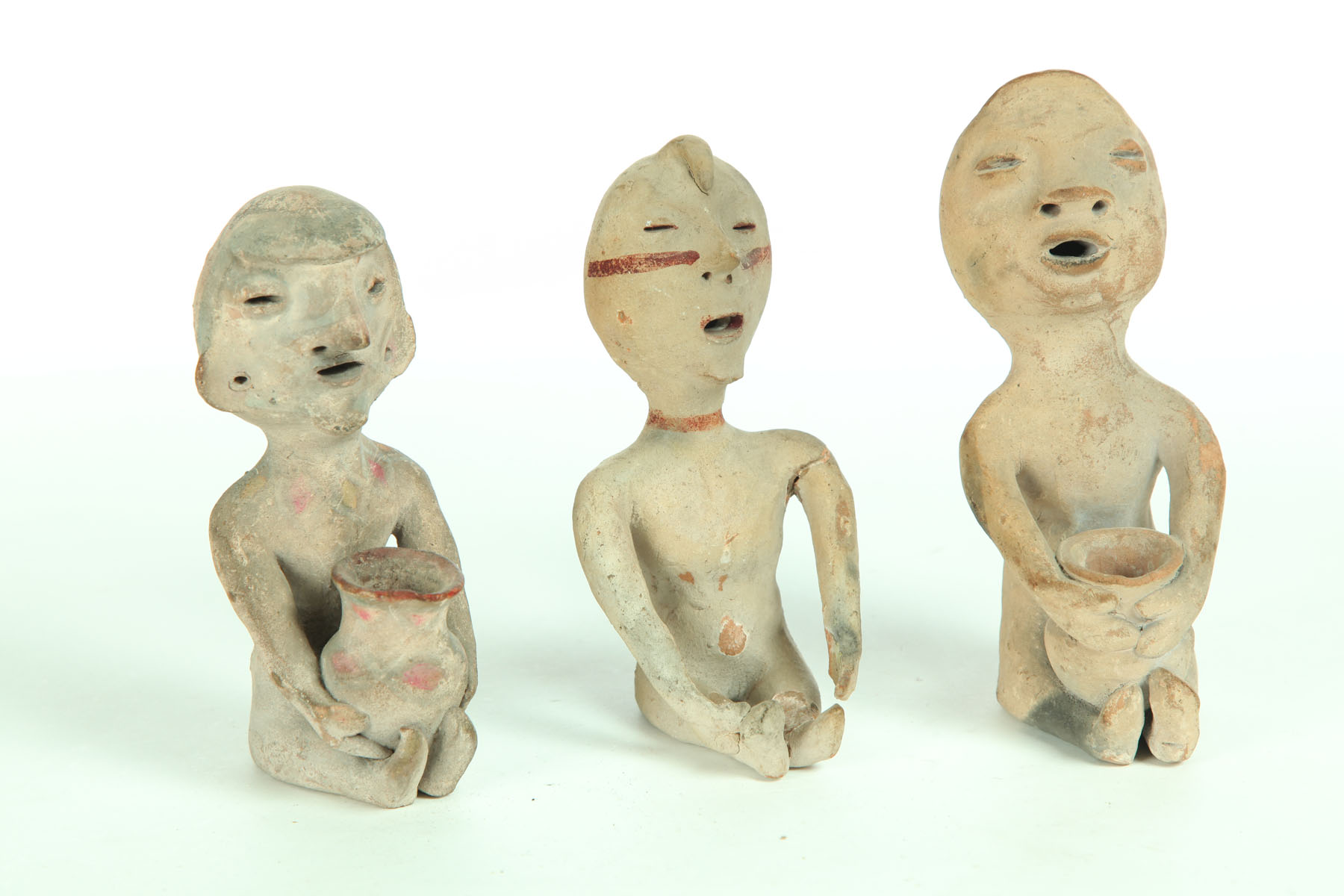 Appraisal: THREE TESUQUE RAIN GOD FIGURES Twentieth century Seated pottery figures