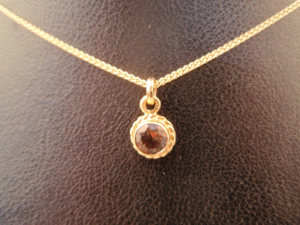 Appraisal: A small circular smokey quartz set pendant on ct chain