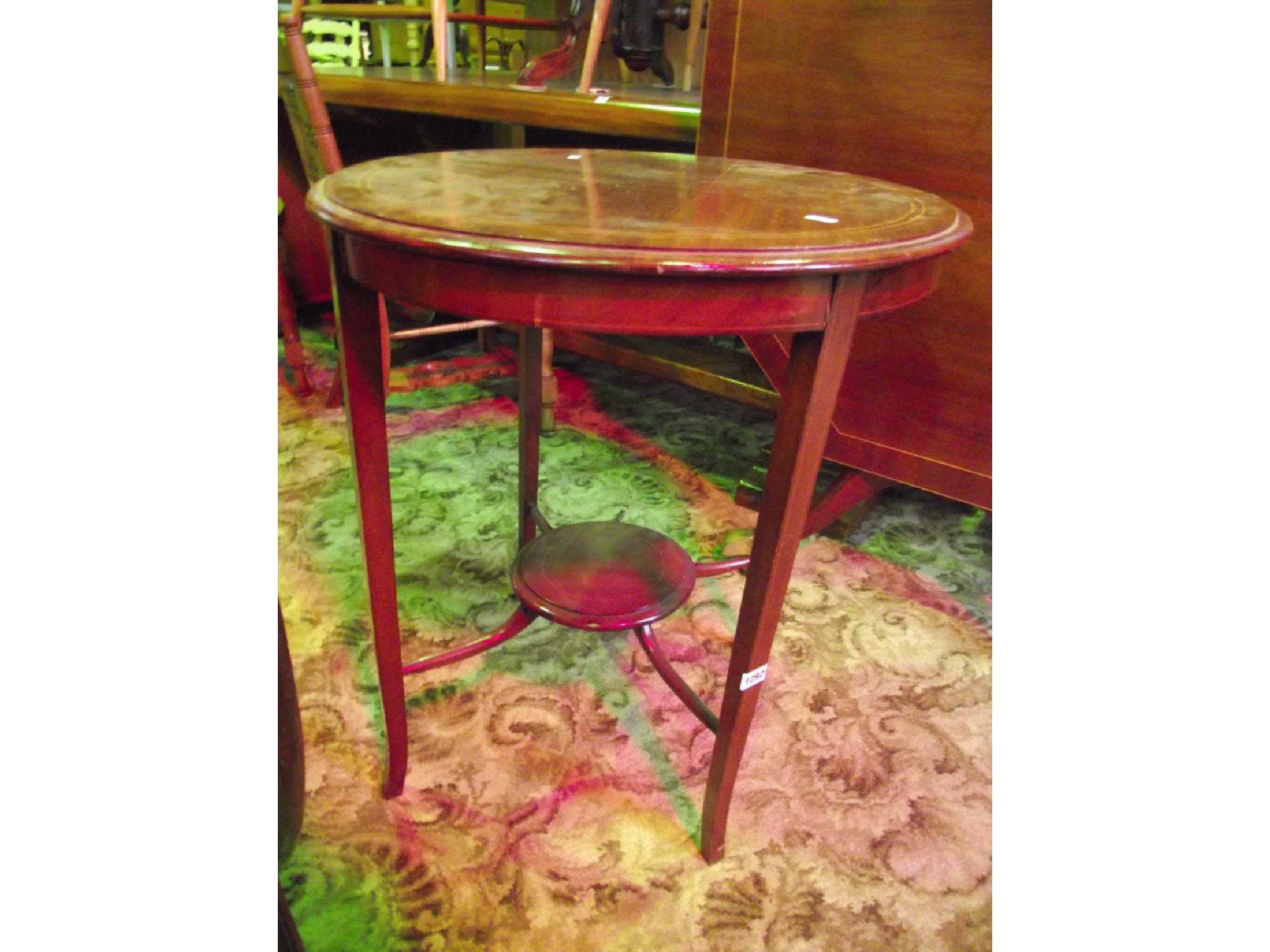 Appraisal: An Edwardian mahogany occasional table of circular form with string