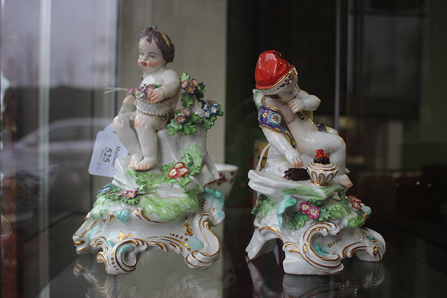 Appraisal: A PAIR OF BOW PORCELAIN FIGURES of putti one resting