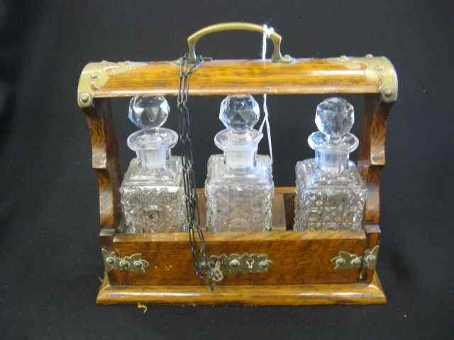 Appraisal: Scarce Diminutive Tantalus Set a trio ofcut glass decanters in