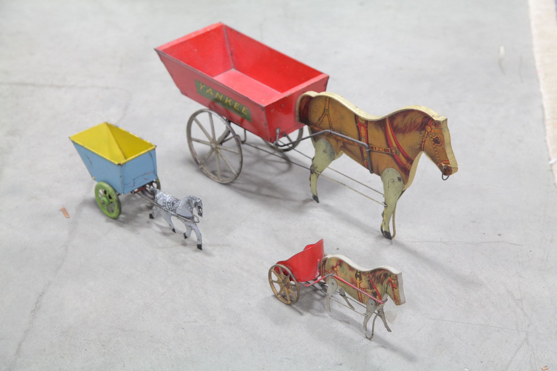 Appraisal: THREE HORSE AND CART TOYS American early th century A