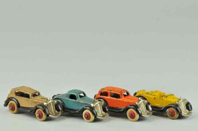 Appraisal: LOT OF FOUR AUTOS Cast iron painted various colors consisting