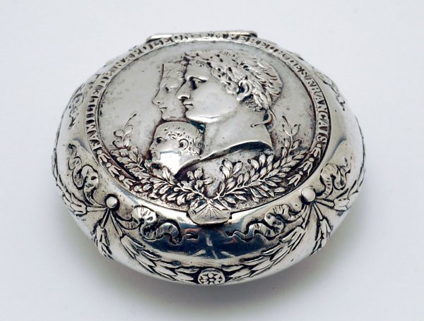 Appraisal: Silver snuff box round in shape body with repousse swagging