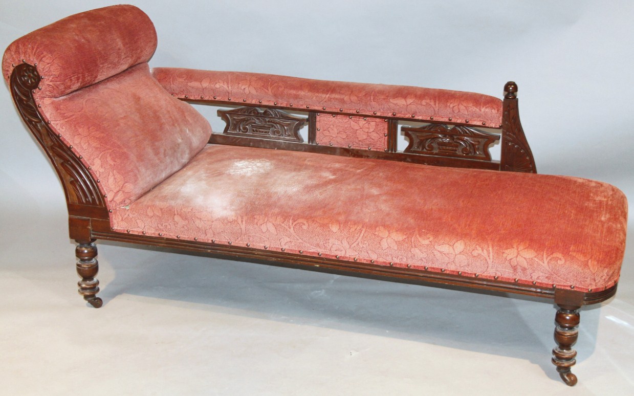 Appraisal: An Edwardian walnut frame chaise longue upholstered in later red