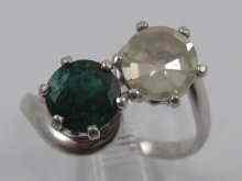 Appraisal: A white metal tests carat gold emerald and diamond two