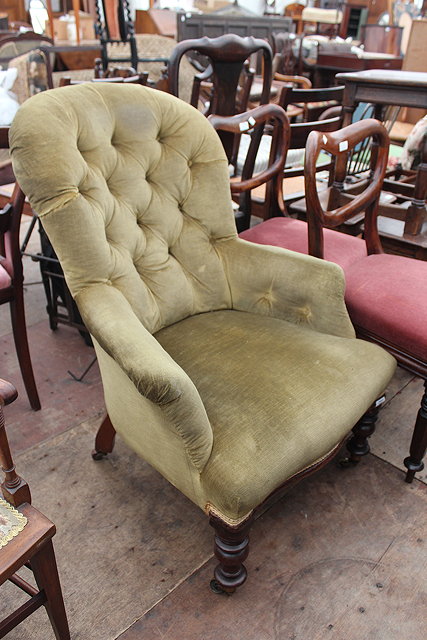 Appraisal: A VIICTORIAN BUTTON UPHOLSTERED ARMCHAIR with arching back serpentine fronted