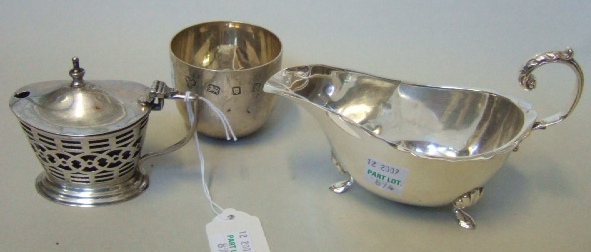 Appraisal: Silver comprising a sauceboat raised on three feet Birmingham a