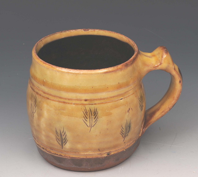 Appraisal: AN EARLY TH CENTURY SLIP WARE MUG by Michael Cardew