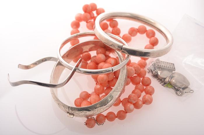 Appraisal: A COLLECTION OF FOUR SILVER BANGLES TOGETHER WITH A STRAND