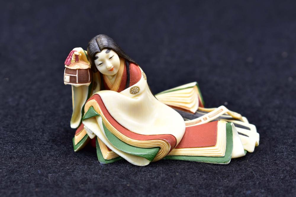 Appraisal: JAPANESE POLYCHROME PAINTED NETSUKE OF A SEATED MAIDENCirca In a