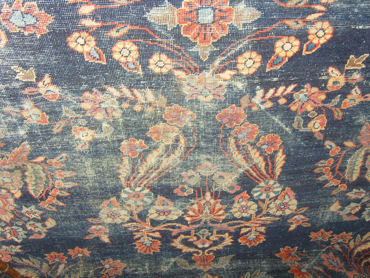 Appraisal: A large red and blue ground eastern wool carpet with