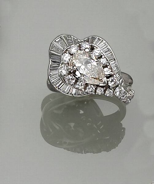 Appraisal: A diamond and platinum ring centering a pear-shaped diamond within