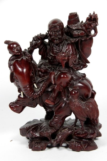 Appraisal: A Chinese root wood carving of an immortal riding an